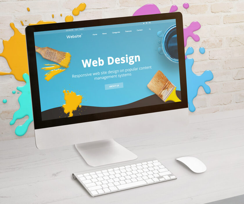 Concept of web design studio with coimputer display and color dr