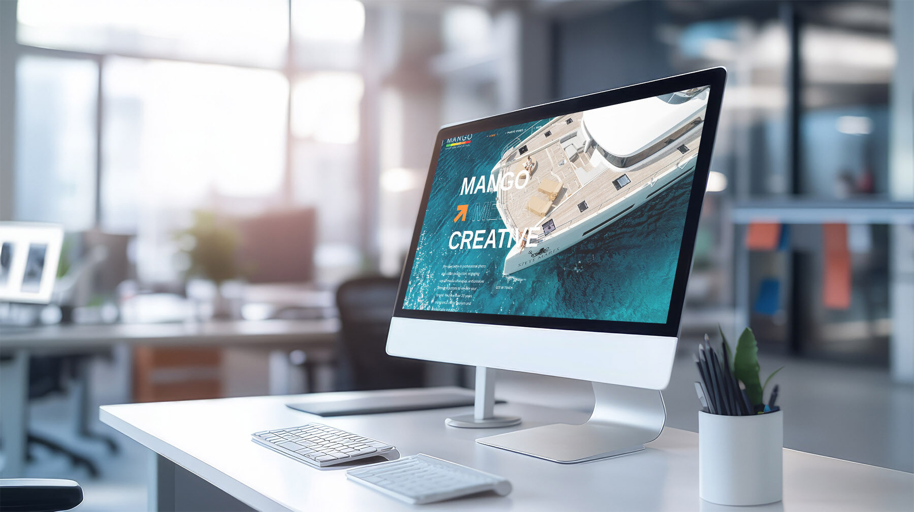 Modern computer display on an office desk with a web design stud